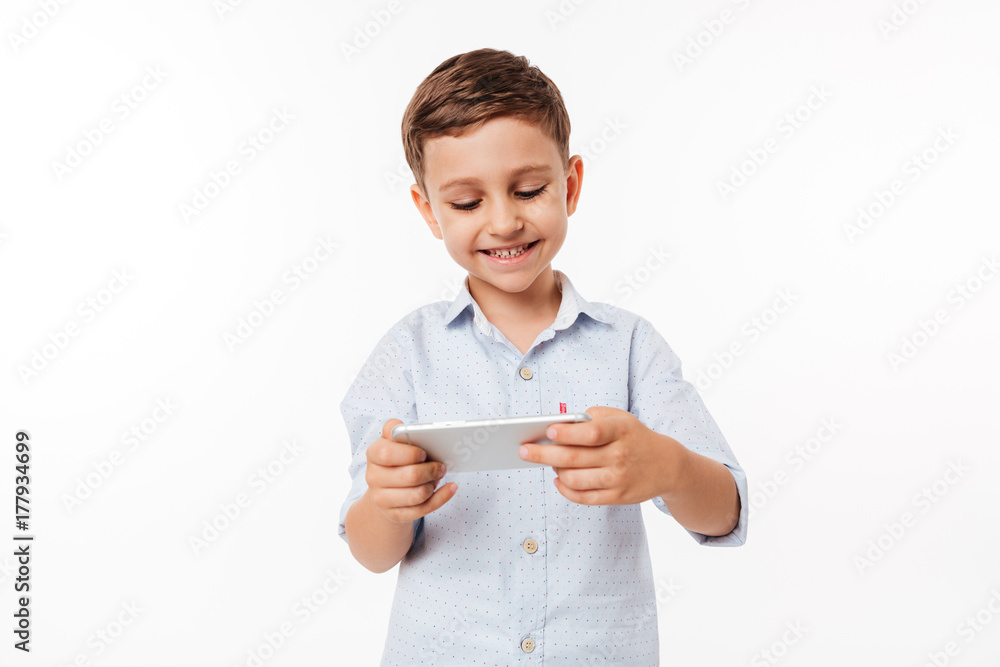 Portrait of a cute little kid playing games on smartphone Portrait of a cute little kid playing games on smartphone