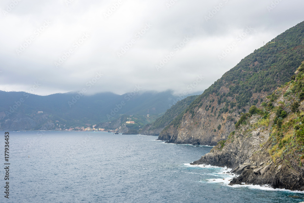 Beautiful view to blue sea and fishing boat, Foggy, tusk day. Vernazza, Cinque Terre, Italy