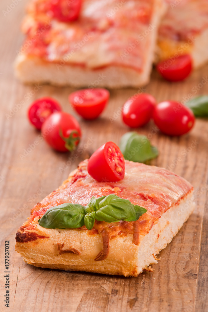 Italian pizza with cheese, tomatoes and fresh basil.