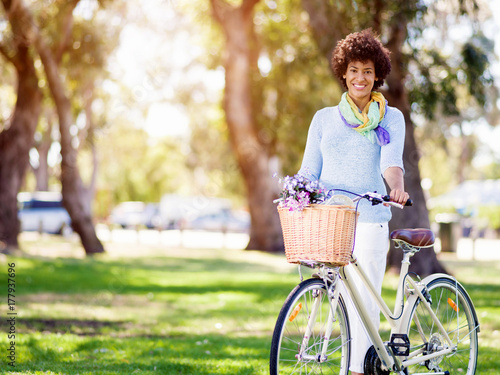 Happy young woman with bicycle