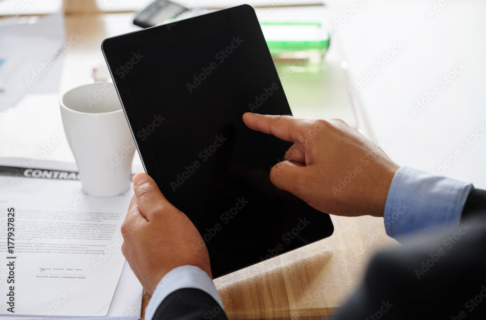 Businesman finger pointing to blank tablet Businesman finger pointing to blank tablet