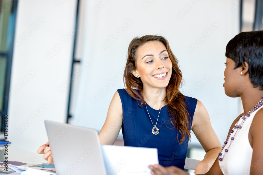Women working together, office interior Women working together, office interior