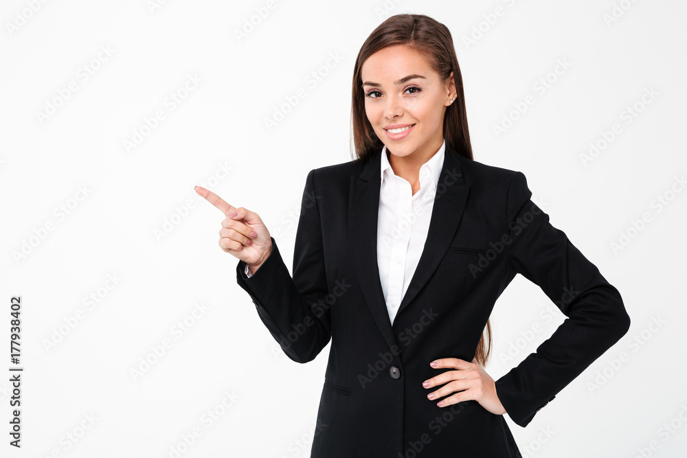 Happy business woman pointing to copyspace. Happy business woman pointing to copyspace.