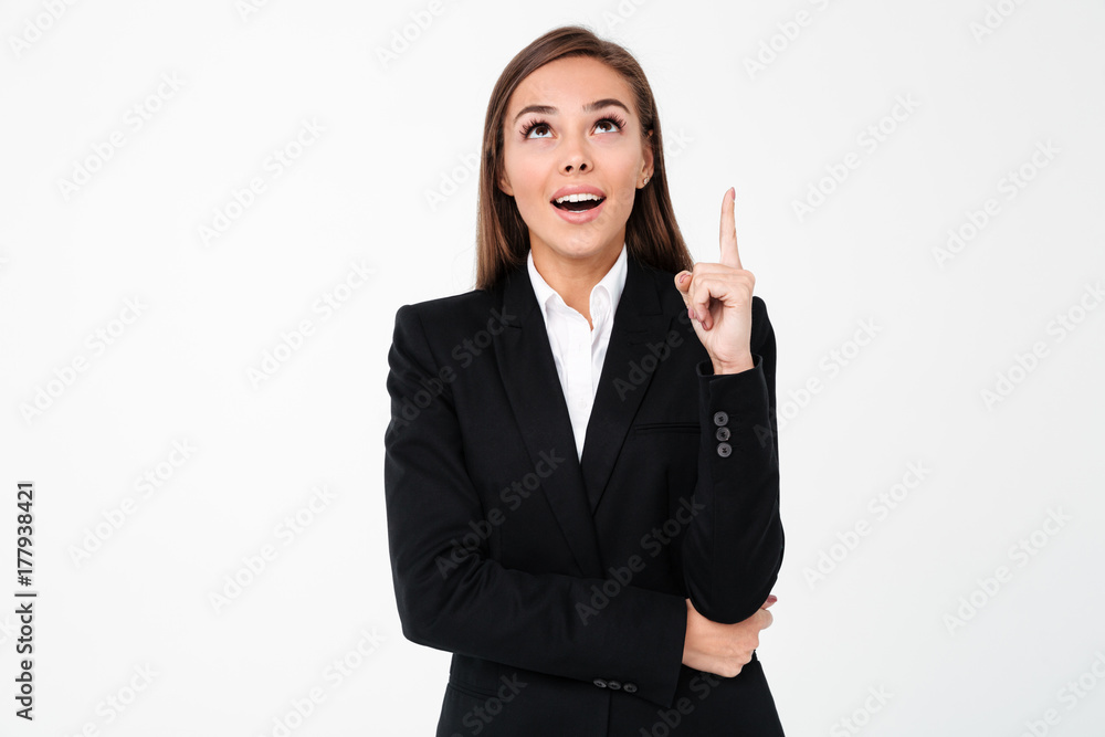 Happy business woman pointing to copyspace. Happy business woman pointing to copyspace.