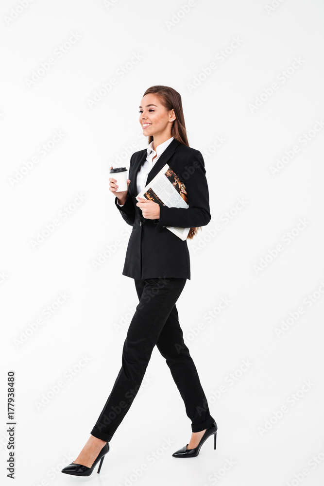 Happy business woman holding newspaper drinking coffee. Happy business woman holding newspaper drinking coffee.