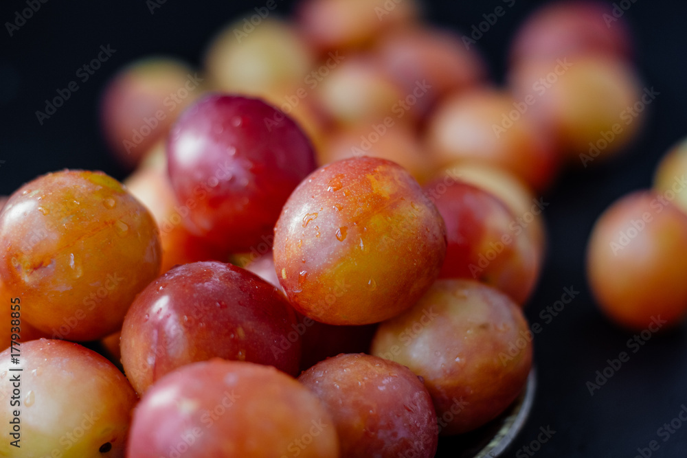 Ripe and beautiful wild plum fruits over black background. Ripe and beautiful wild plum fruits over black background.