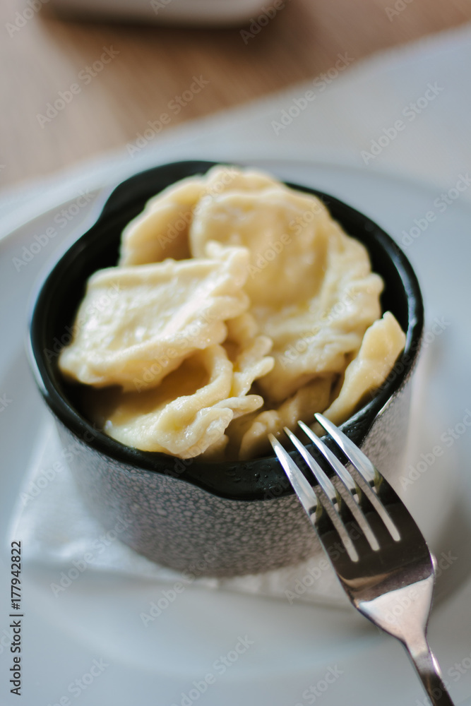 Russian food - dumplings on ceramic bowl. Russian food - dumplings on ceramic bowl.