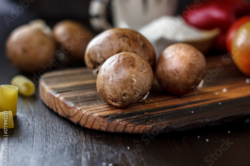 Food - mushrooms on wooden board on kitchen.