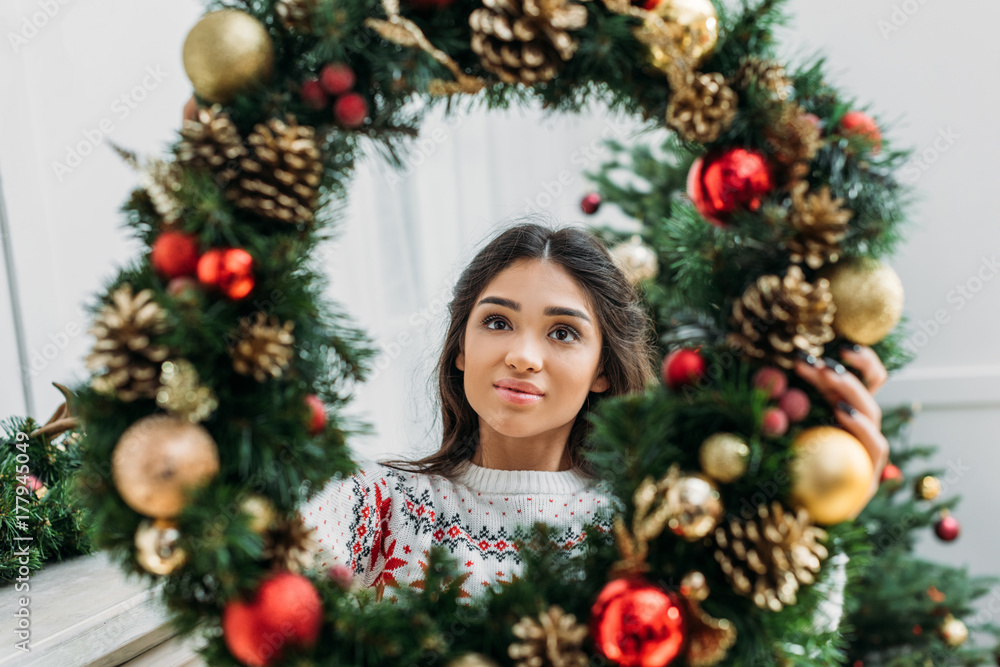 woman holding christmas wreath woman holding christmas wreath