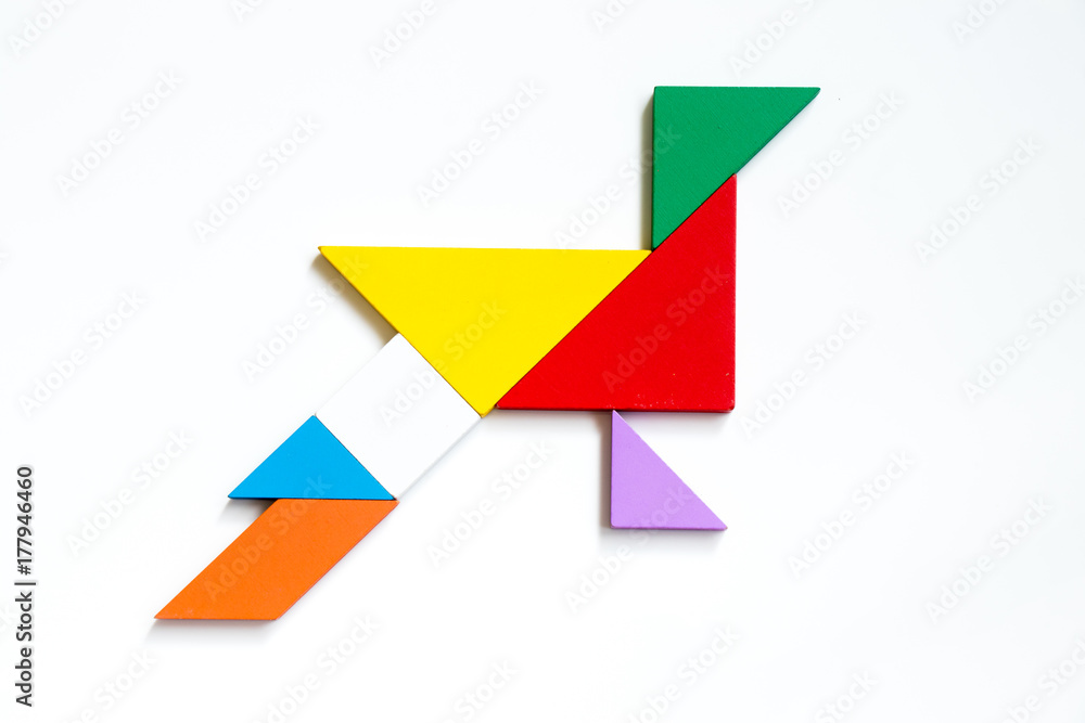Colorful wood tangram puzzle in peacock shape on white background Colorful wood tangram puzzle in peacock shape on white background