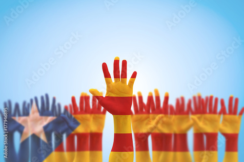 Catalan separatism concept with Senyera estelada (Eastern Catalan) flag on Catalunya people's hand open palms (isolated with clipping path) Catalonia supporters for national independence vote photo