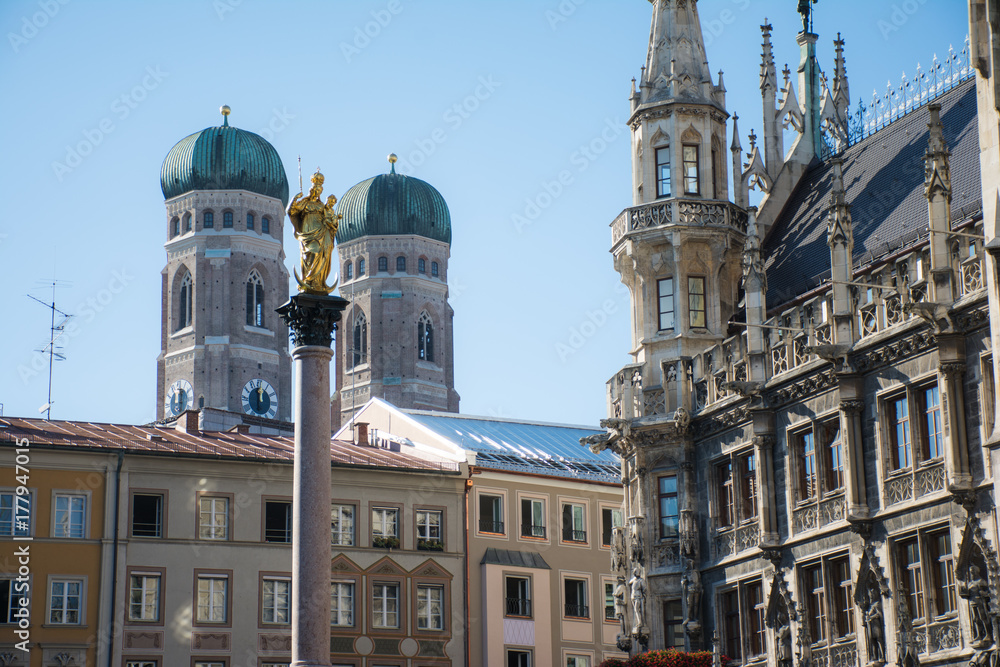 Golden sculpture of St. Mary with the Church of Our Lady. View from Marienplatz in Munich, Germany