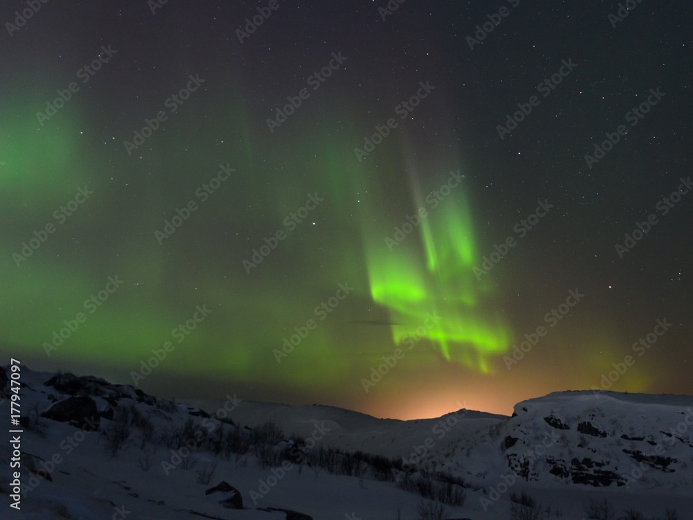 Snow covered the hills and in the sky stars, clouds and northern lights. Snow covered the hills and in the sky stars, clouds and northern lights.