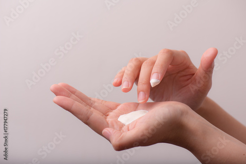 close up of women hands receiving sunblock cream lotion