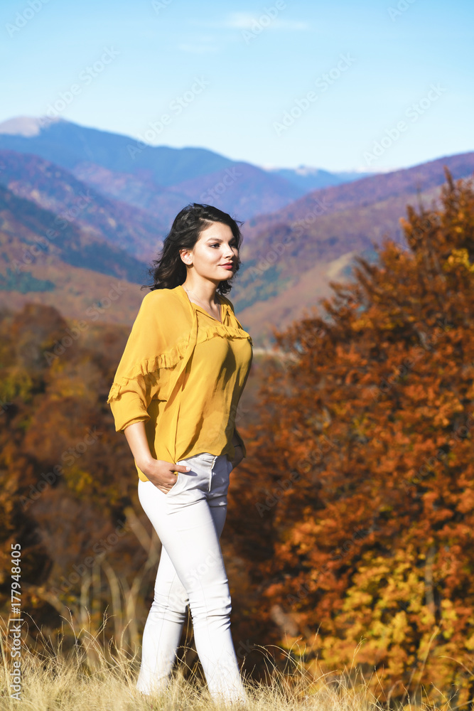 Beautiful young brunette enjoys a sunny day of autumn in nature Beautiful young brunette enjoys a sunny day of autumn in nature