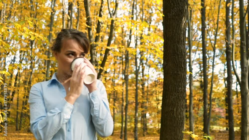 Woman with coffee in park Woman with coffee in park