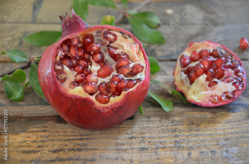 Ripe pomegranate fruit on wooden background. with leave