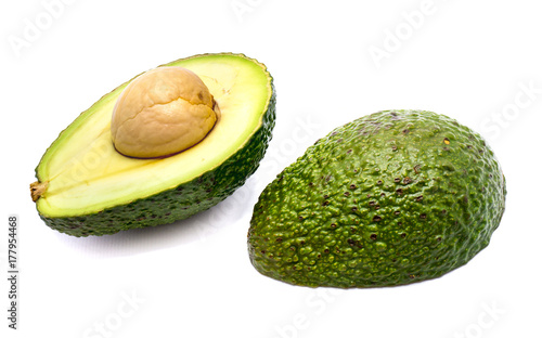 Avocado halves (Persea americana, alligator pear) with a stone isolated on white background