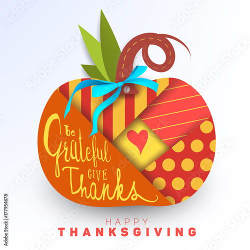 Happy Thanksgiving greeting card, background, banner, layout, template. Beautiful paper cutout pumpkin with different geometric pattern, heart, blue silk bow and lettering. Patchwork, handmade card