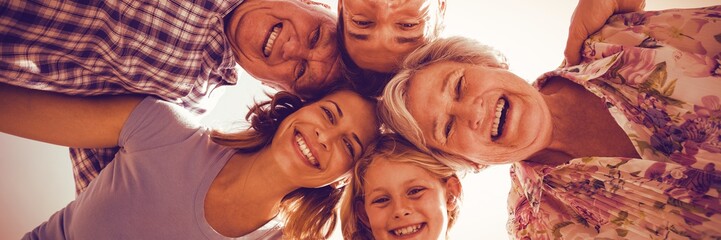 Cheerful family forming huddle