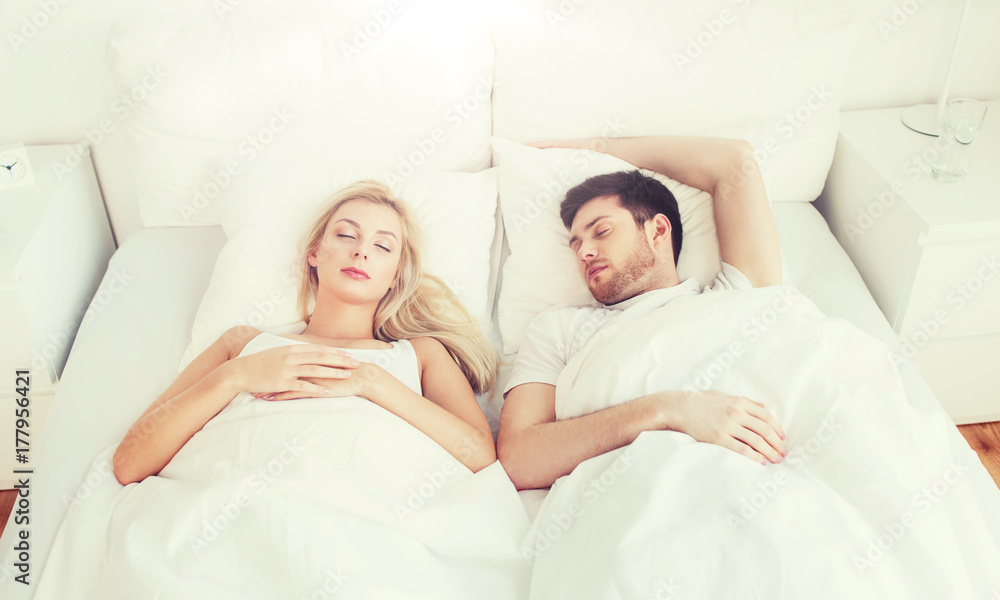 happy couple sleeping in bed at home happy couple sleeping in bed at home