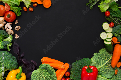 Plenty of fresh vegetables on black background with copy space