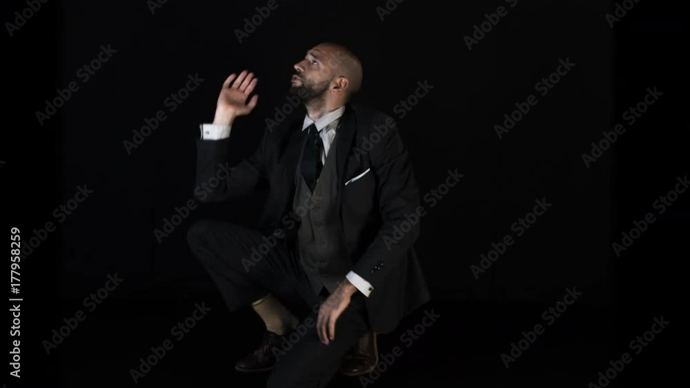 a skillful male dancer in a smart suit dancing in a contemporary style. a skillful male dancer in a smart suit dancing in a contemporary style.