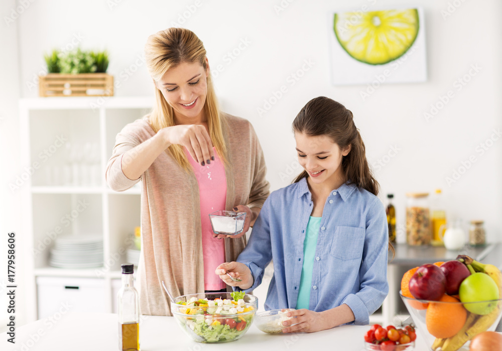 happy family cooking salad at home kitchen