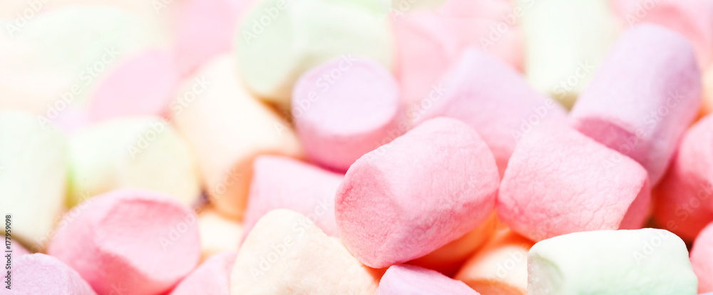 Colorful mini marshmallows in a blue bowl as background, macro. Fluffy marshmallows texture and pattern. High Resolution image, Soft focus Colorful mini marshmallows in a blue bowl as background, macro. Fluffy marshmallows texture and pattern. High Resolution image, Soft focus