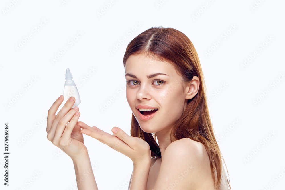woman holds eye drops and smiles, advertising woman holds eye drops and smiles, advertising