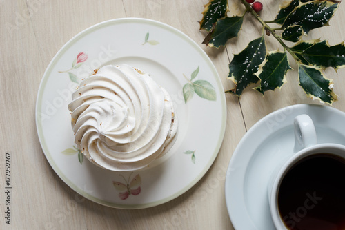 Sweet white meringue and cup of hot tea