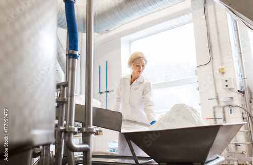 woman working at ice cream factory conveyor