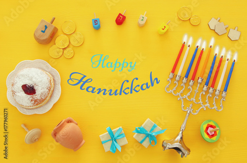 Top view image of jewish holiday Hanukkah background with traditional spinnig top, menorah (traditional candelabra)