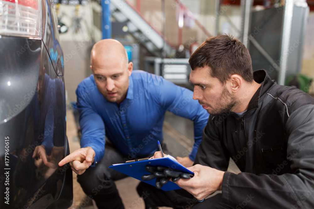 auto mechanic and customer looking at car auto mechanic and customer looking at car