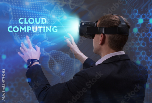 Business, Technology, Internet and network concept. Young businessman working in virtual reality glasses sees the inscription: Cloud computing