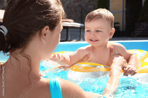 Child swimming lesson. Cute...