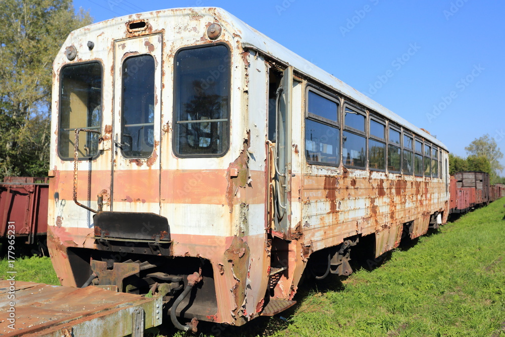 Ruined passenger car. Rusty train on railway tracks. Ruined passenger car. Rusty train on railway tracks.