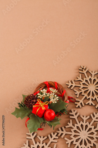 Wood snowflakes, creative wreath on beige background with copy space. Vertical.
