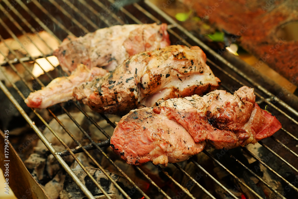 medium roasted  steak  pork on iron grill.Thailand local tradition grill pork