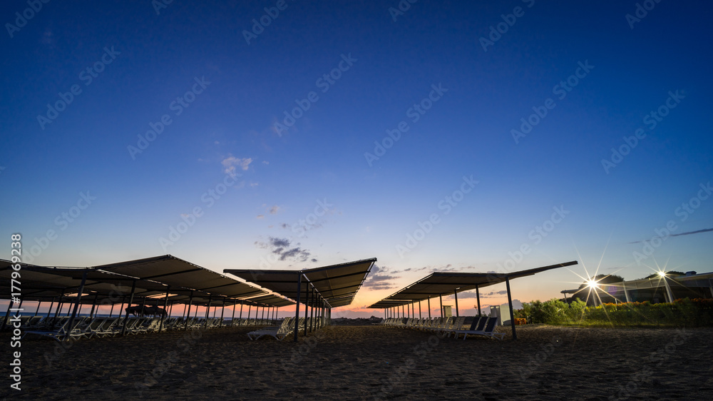 deckchairs on a beach by night