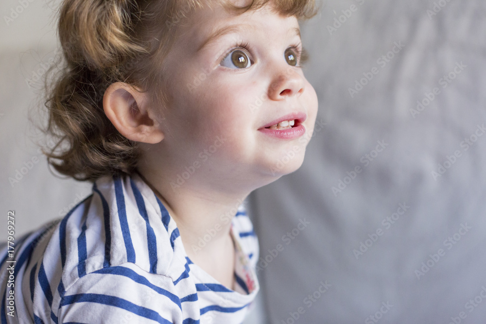 beautiful little girl standing on bed and smiling. Fun, home, indoors. Lifestyle beautiful little girl standing on bed and smiling. Fun, home, indoors. Lifestyle