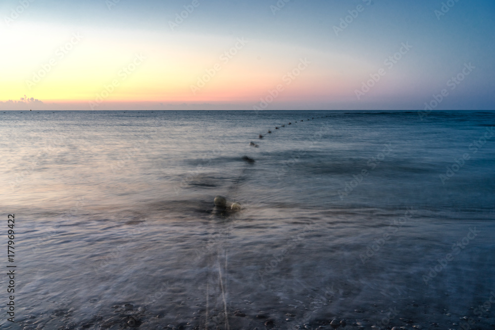 sunset over a beach on a warm day sunset over a beach on a warm day