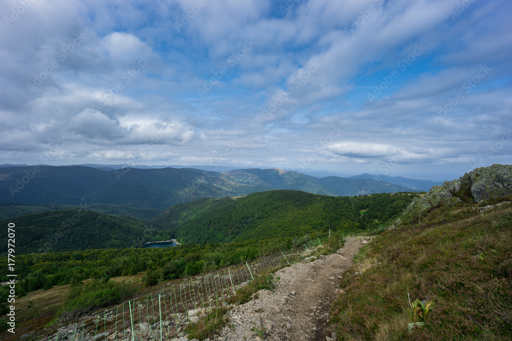 France - Hike trail with fence on top of mountain grand ballon in french vosges France - Hike trail with fence on top of mountain grand ballon in french vosges