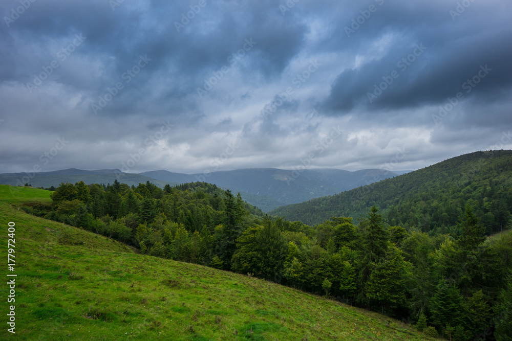 France - Dramatic sky cloud formations over french forest and mountains in alsace