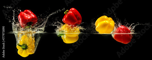 Group of bell pepper falling in water
