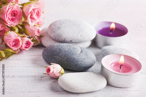 SPA composition with rose flowers, lit candles