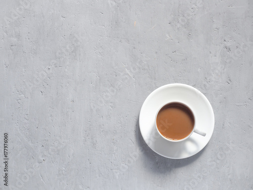 Cup of fragrant coffee on a background under the concrete. Minimalism is the view from the top. Copy space