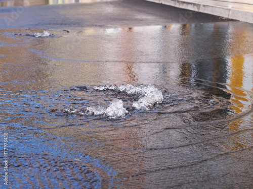 Rain water flows up out of clogged drain cover, causing flood in Selce, Croatia