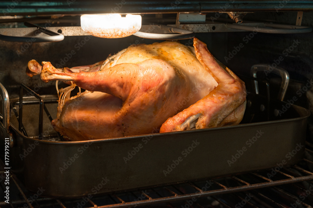 Naklejka premium Fresh turkey roasting in an oven