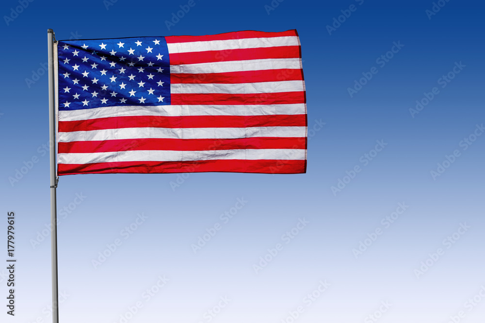 Fototapeta premium USA Flag on Pole with Blue Background